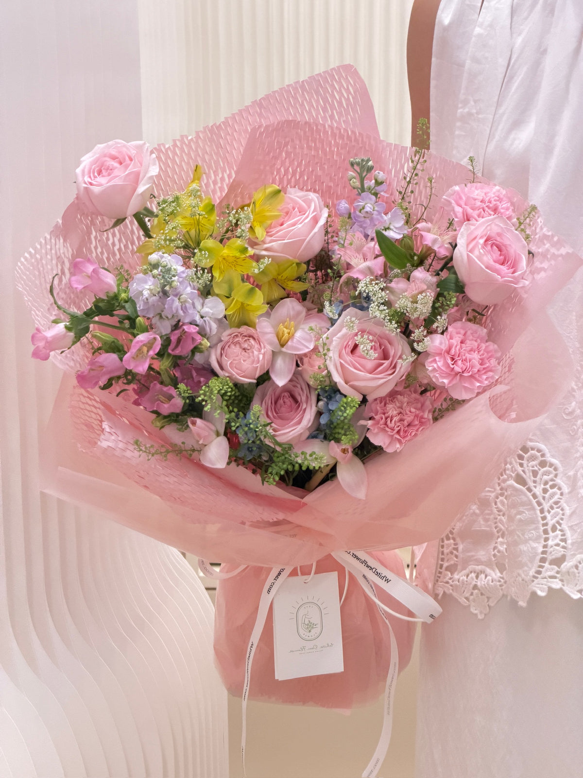 Hand-tied pastel pink mixed flower bouquet with delicate white ribbon, perfect for birthday and anniversary gifting