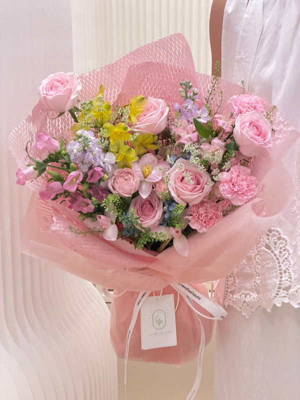 Hand-tied pastel pink mixed flower bouquet with delicate white ribbon, perfect for birthday and anniversary gifting