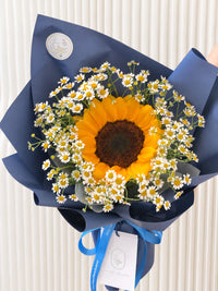 Full view of Little Sunshine minimalist graduation bouquet with sunflower and white daisies in elegant navy blue wrapping by White Dew Flower Singapore.